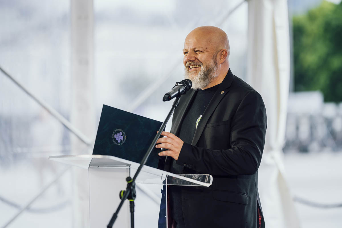 smiling man at the microphone.
