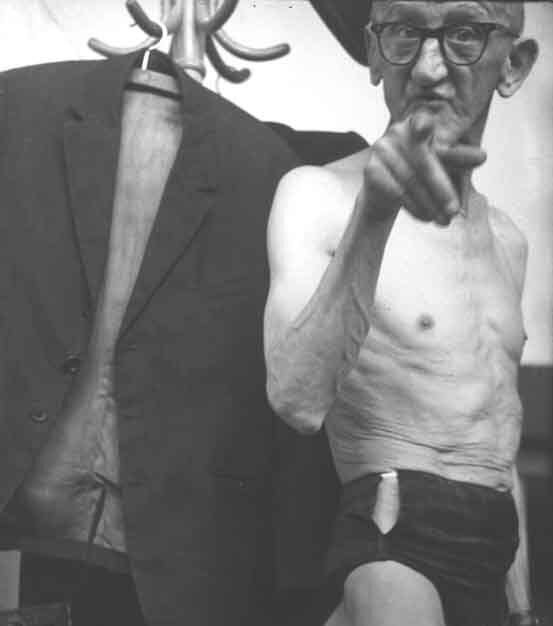 Black and white photograph showing an older, slim. man.