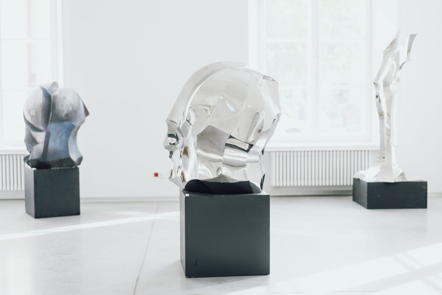 View of the sculpture on a pedestal in the gallery.