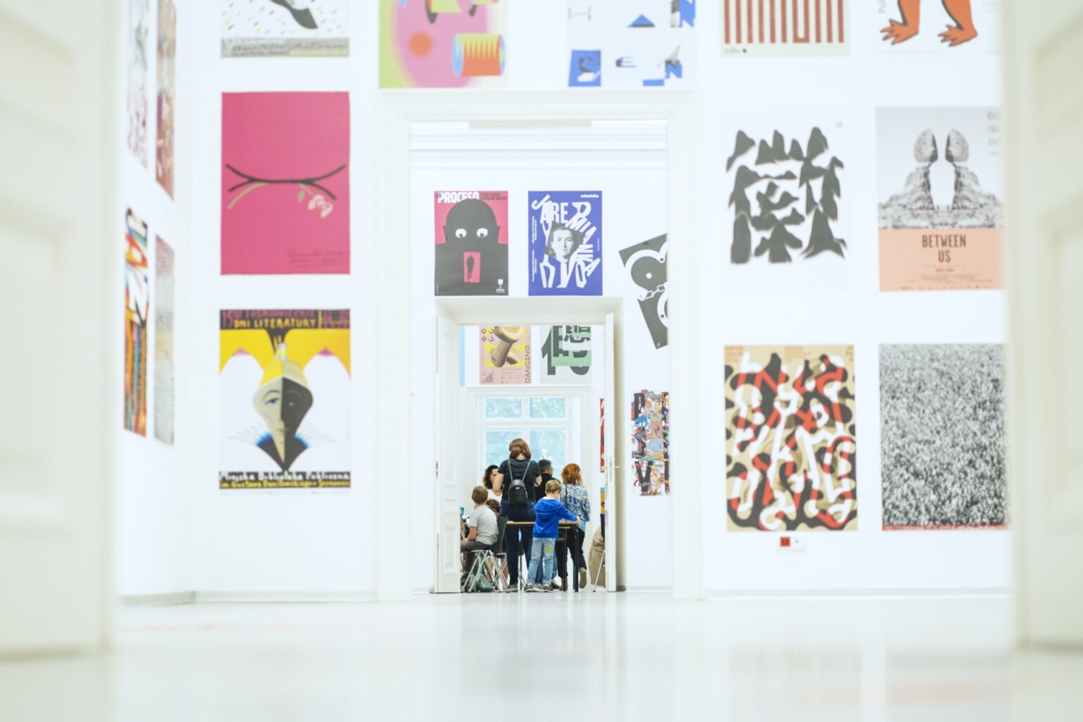A view of the gallery with a display of posters on the wall.