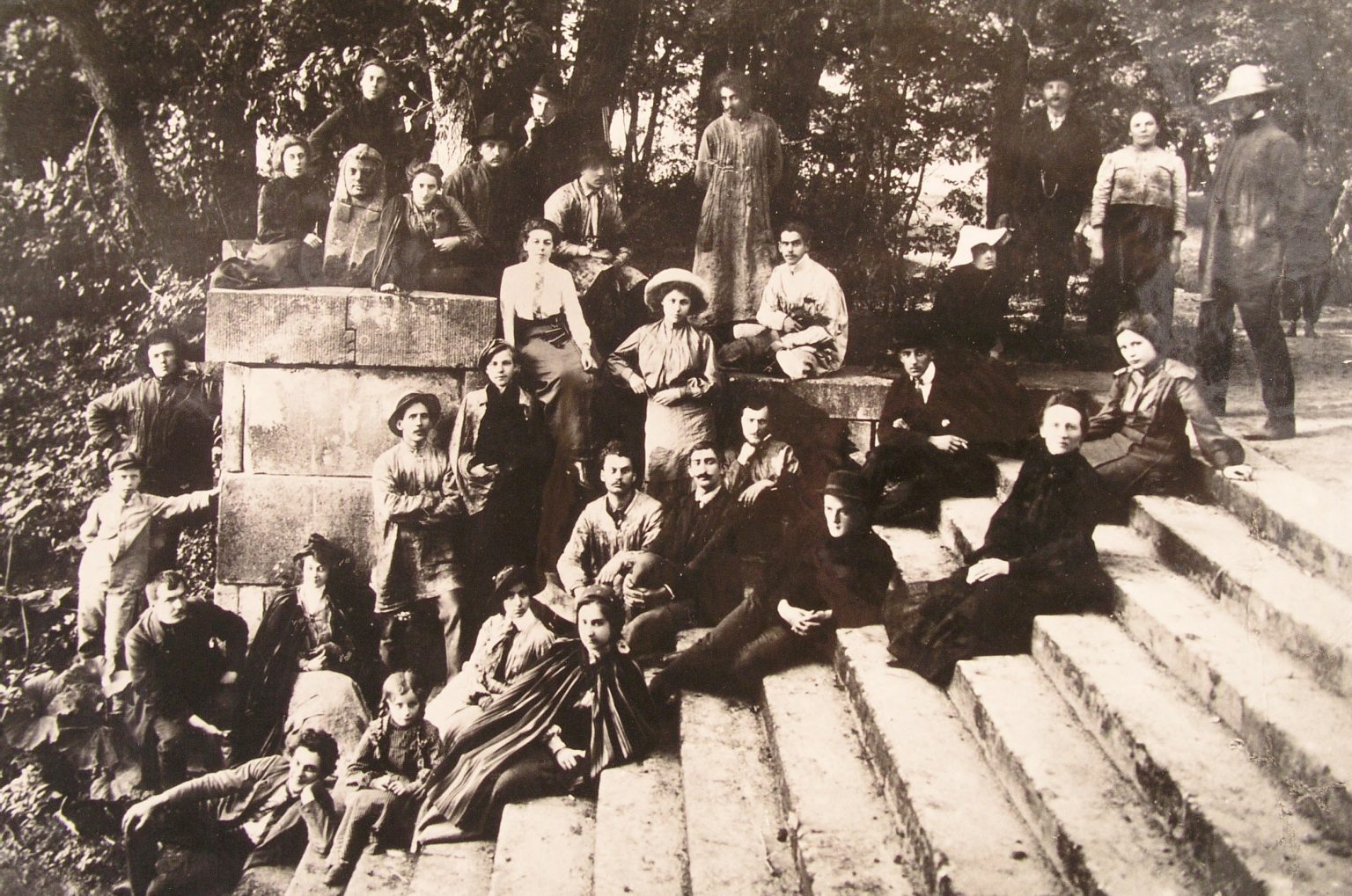 Group photo from the open-air workshop showing a group of students sitting on the stairs