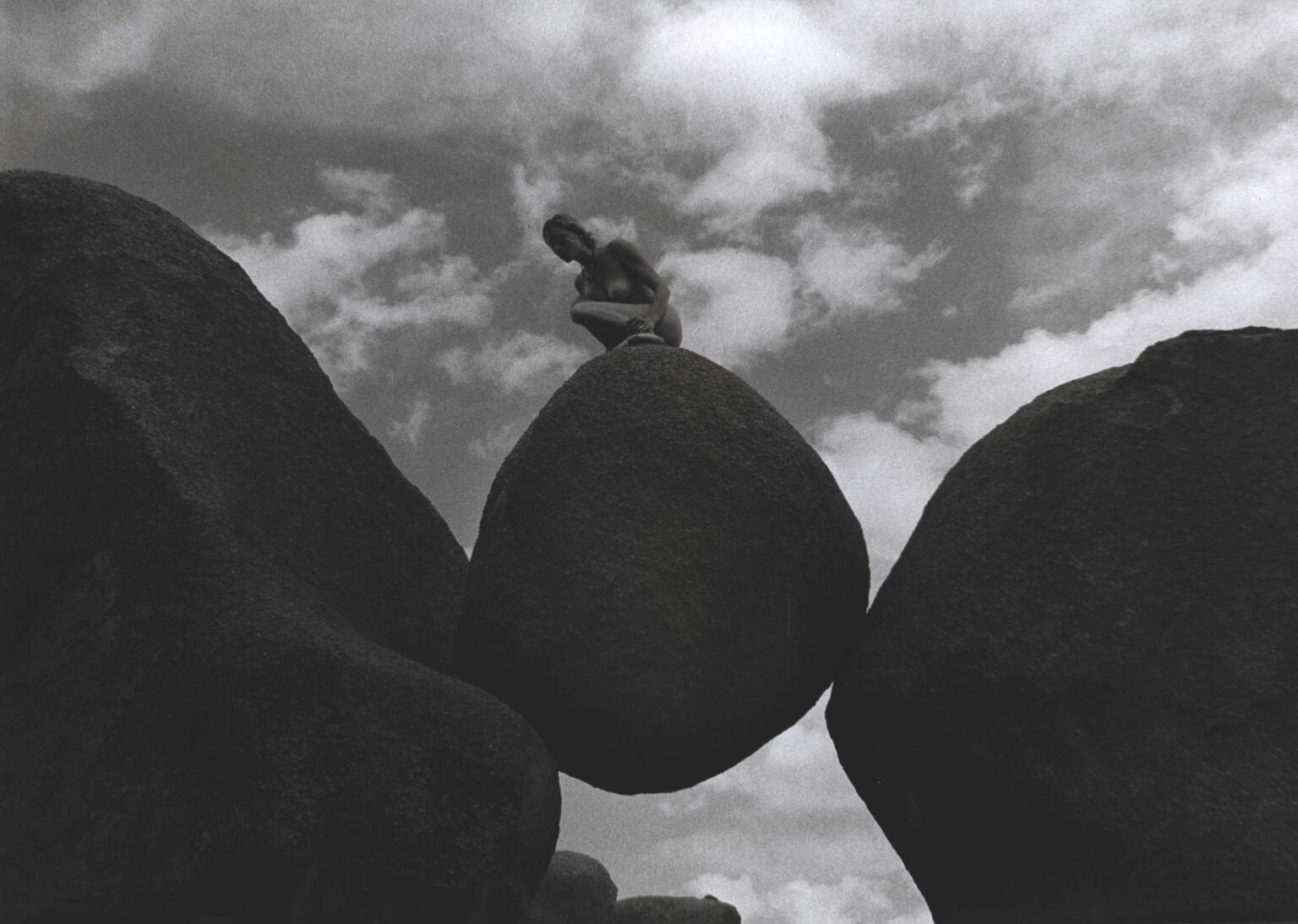 a b-w picture of a woman on the rocks